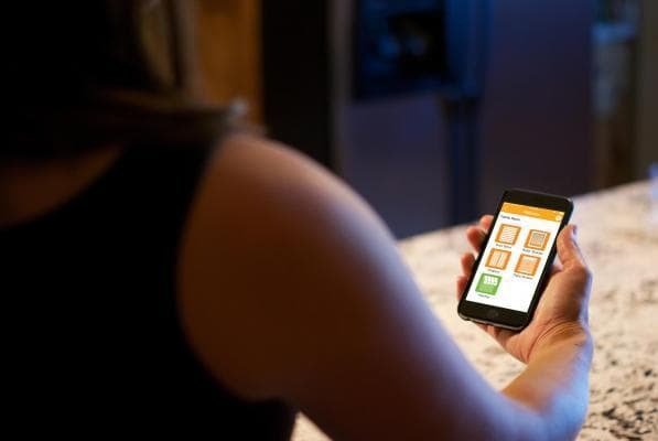 A Pennsylvania homeowner checking their MyLInk app, allowing them automated control over their Sunesta awning.